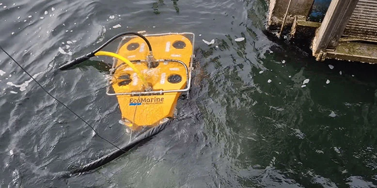 OmniBot floating beside a dock during an underwater demonstration